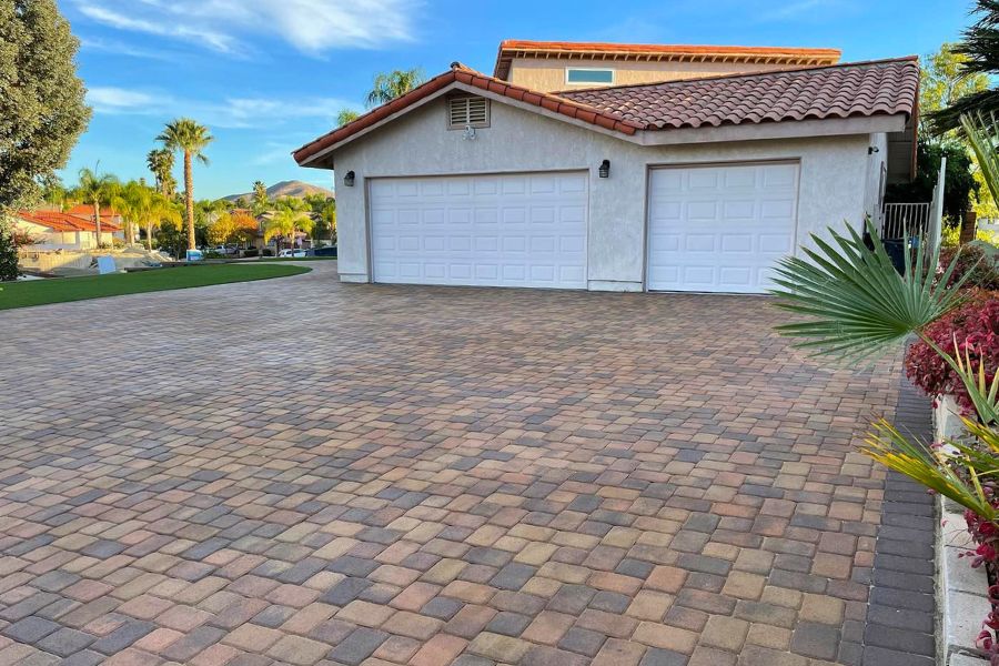 Interlocking driveway pavers installed in front of a residential home